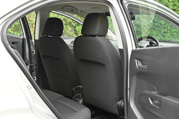 The rear passenger seat is wide and clean. Leather interior, side view, solar sunroof, buttons, Nappa leather, beige,black