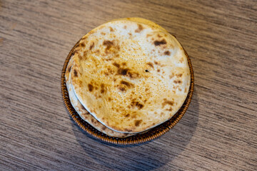 Tandoori roti on a wooden table background closeup