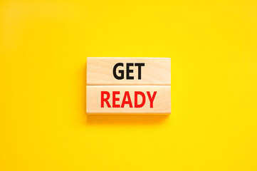 Get ready symbol. Concept words Get ready on wooden blocks on a beautiful yellow table yellow background. Business, support, motivation and get ready concept. Copy space.