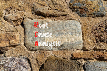 RCA root cause analysis symbol. Concept words RCA root cause analysis on beautiful big stone in stone wall. Beautiful stone wall background. Business and RCA root cause analysis concept. Copy space.