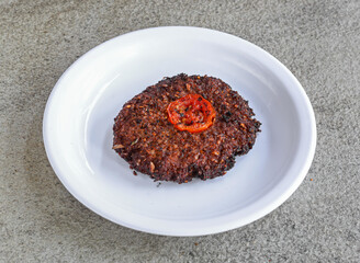 beef chappal kabab served in plate isolated on grey background top view of pakistani and indian spices food