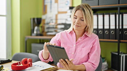 Young blonde woman business worker using touchpad working at office