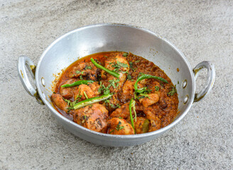 chicken karahi korma with gravy served in plate isolated on grey background top view of pakistani and indian spices food