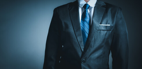 businessman standing on dark gradient background. business concept. suit.