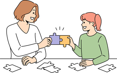Smiling mother and daughter do puzzles together