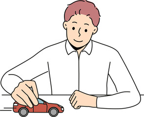 Businessman play with car in office
