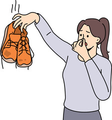 Fototapeta premium Woman cover nose disgusted with smelly shoes