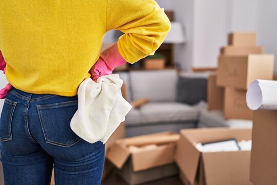 African American Woman Standing Holding Cloth At New Home