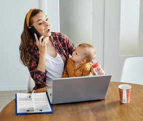 mother baby laptop computer child woman working business mobile phone smartphone parent mom family
