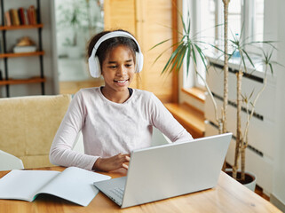 child laptop computer teenage home girl education homework headphone learning earphone kid listening technology teen sound internet childhood listen audio student