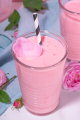 Rose flower milkshake, asian Moon milk drink. Pink matcha cocktail with rose petals.