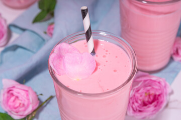 Rose flower milkshake, asian Moon milk drink. Pink matcha cocktail with rose petals.