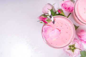 Rose flower milkshake, asian Moon milk drink. Pink matcha cocktail with rose petals.