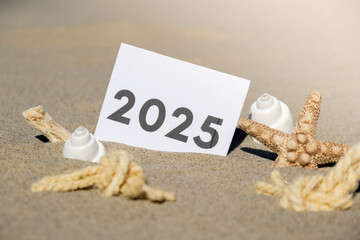 2025 text start new year symbol on paper greeting card on background of starfish summer vacation...