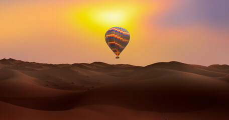 Hot air balloon flying over beautiful sand dunes in the Sahara desert - Sahara, Morocco