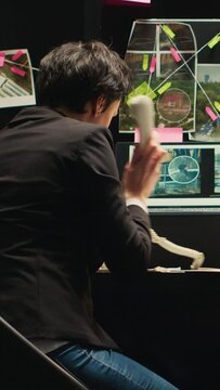 Vertical video Detectives rushing to catch culprit, finding out about criminal whereabouts over office phone call. Team of inspectors running to capture killer suspect with incriminating proof