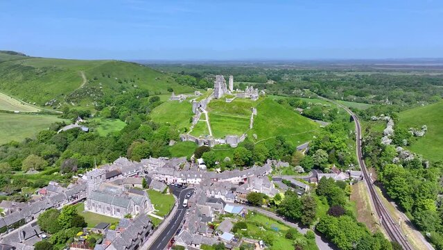 Aerial view of the village and Monument of Corfe Castle, Dorset, England, during a sunny spring day