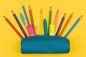 Top view of pencil case with school supplies