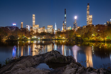 Billionaires' Row skyscrapers from Central Park Lake at night. Manhattan, New York City