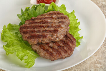 Grilled beef burger cutlet with sauce