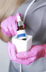 Nail technician holding pedicure oil 