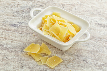 Sliced parmesan cheese heap in the bowl