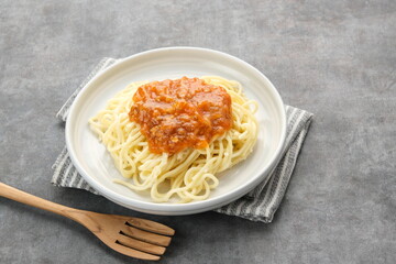 Spaghetti Bolognese on dark background, copy space
