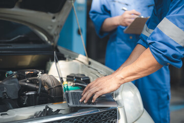 Two professional car mechanics are helping to inspect a customer's car being brought in for repair, all types of auto specialists, expert car repairs and certified auto repair centers.