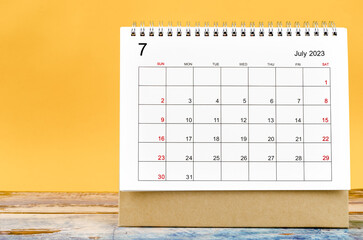 The July 2023 Monthly desk calendar for 2023 year on yellow background.