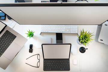 Top view of a work desk. Devices screens mockup. Graphic design home studio. Desktop. Blank screen.