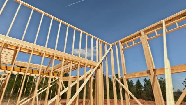 Using wooden beams sticks as framework for construction of new home