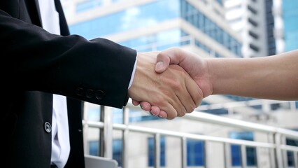 Close up hands of business people shaking hands. Shaking hands with colleagues. Partnership, cooperation, teamwork, congratulations, agreement