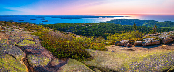Panorama of the Cadillac Mountain Overlook in Acadia National Park, Bar Harbor, Maine, beautiful expansive vista over glacial rocks at sunrise  © Naya Na