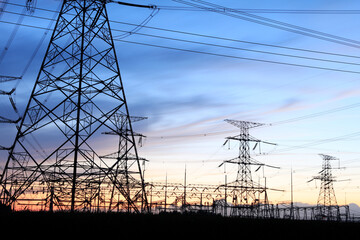 In the evening, the silhouette of high voltage towers