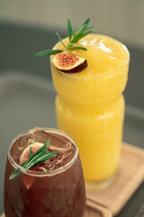 Ripe fig fruits with leaf on top Fig Juicy smoothie. Beautiful sweet fresh organic figs on a wooden table. Label design. Healthy vegan food