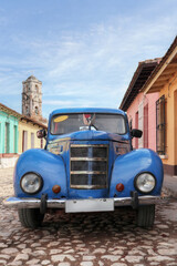 Old car inside a colorful Cuban Town