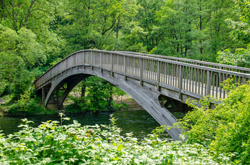Heimbach, Germany, May 25, 2023: wooden arch bridge for pedestrians across the river Rur in an overwhelmingly green environment