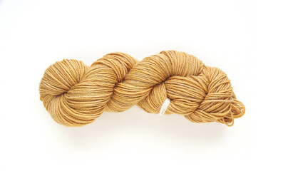Beige twisted yarn hank on a white background, hand dyed wool skein flat lay top view