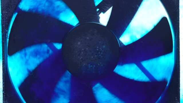 PC fan spinning in blue water. Slow motion