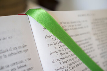 Open Book of Psalms, green bound bookmark over the page