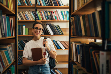 A student stuying and reading books in a public library.