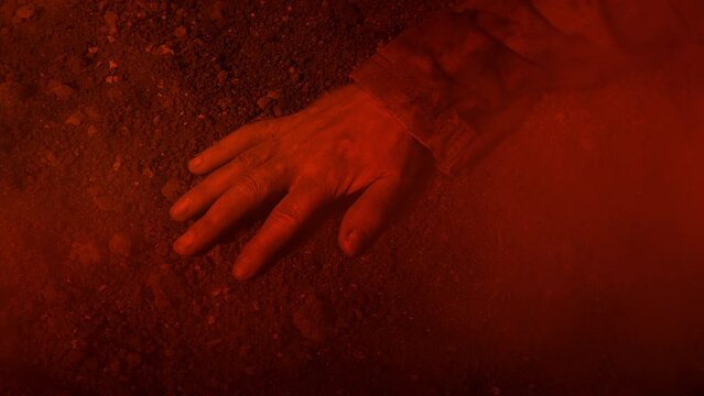 Fire And Smoke Over Man's Arm On The Ground
