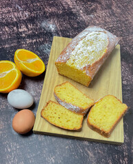 plum cake flavored with oranges and cinnamon and icing sugar.