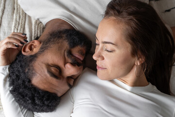 Multiethnic American couple embracing at home.