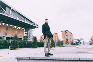 young bearded business man posing looking away