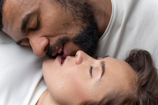Multiethnic American couple embracing at home.