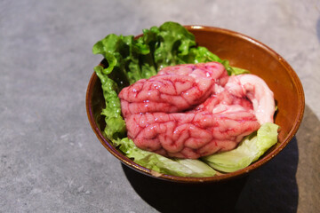 close up a bowl of pig's brain. Raw food ingredient for Chinese hotpot 