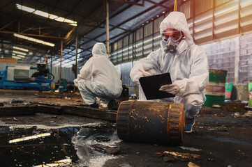 chemical specialist wear safety uniform and gas mask inspecting chemical leak in industry factory