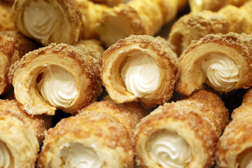 Rolls of puff pastry with cream. Sweet pastries for dessert