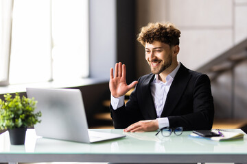 Portrait of a cheerful man having video call on laptop